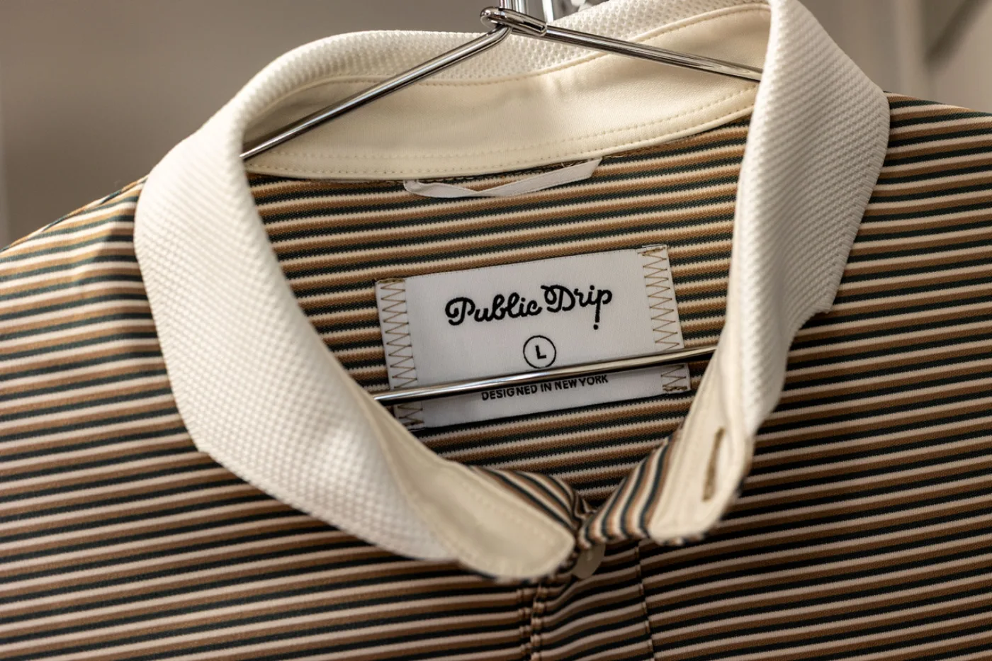 Striped polo with Public Drip label