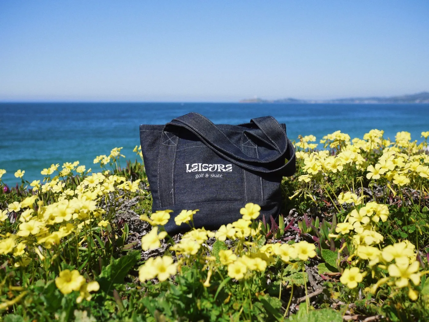 Denim Leisure tote in yellow wildflowers by the sea